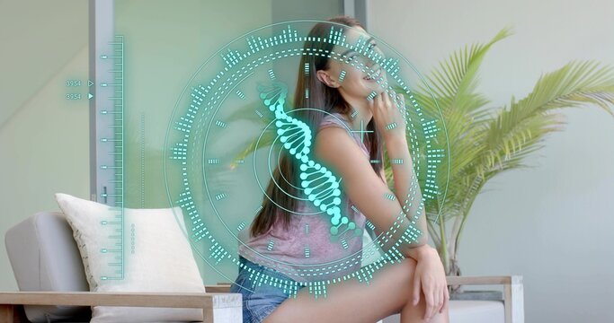 Sitting woman mauve tank denim shorts touching chin on wooden chair with DNA HUD, copy space