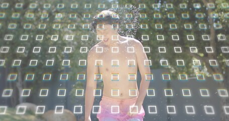 Running shirtless Asian man laughing, passing through park sprinkler, wearing pink trunks, grid