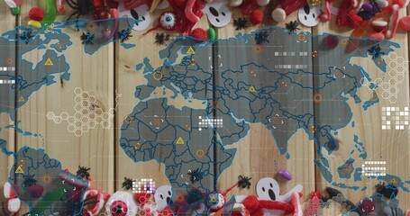 Overlaying translucent world map and HUD on wooden plank surface, framing candies, ghosts, spiders