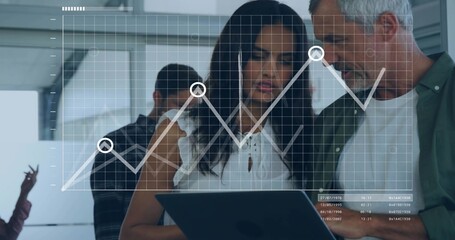 Studying woman in white blouse sharing tablet with team in modern office, line graph overlay