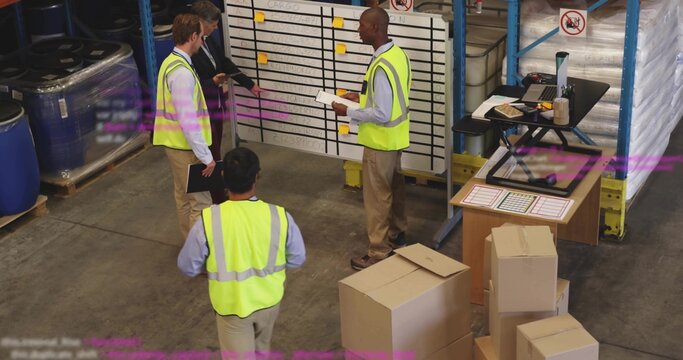 Gathering warehouse team wearing safety vests checking schedule at staging, whiteboard and boxes - Powered by Adobe