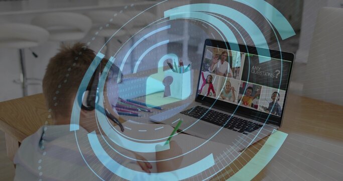 Student writing with green pencil in home table, wearing headset and viewing laptop padlock HUD