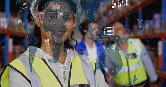 Monitoring Hispanic worker coordinating loads at warehouse with hi-vis vests, digital map overlay - Powered by Adobe