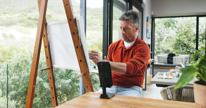 Mature man, painting and phone with canvas for art vlog, online tutorial or creative tips in home. Person, artist or painter with mobile smartphone, color palette or artwork for content creation
