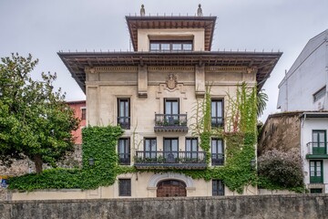 Historic Stone Palace Building Facade with Vine Climbing in Lekeitio, Spain