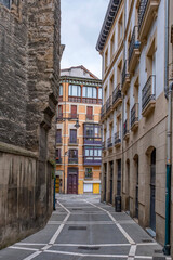 Naklejka premium Narrow Street with Colorful Buildings and Medieval Wall, Pamplona Old Town