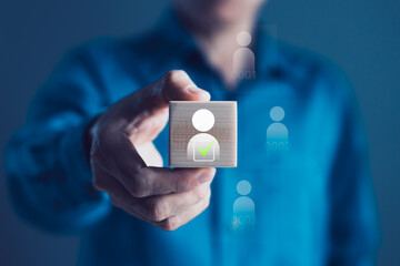 Businessman Holding Wooden Block with Selected Human Icon for Employee Approval, Candidate...