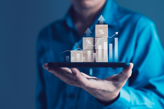 Businessman Holding Smartphone with Stacked Wooden Blocks and Growth Chart for Financial Growth, Investment Return, and Economic Analytics