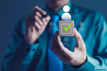 Businessman Holding Wooden Block with Human Icon and Green Check Mark for Recruitment, HR Selection, Talent Acquisition and Hiring Process