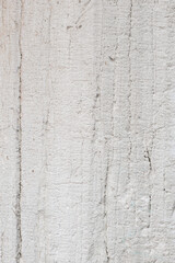 Textured concrete wall with subtle lines and markings in a modern space during daylight