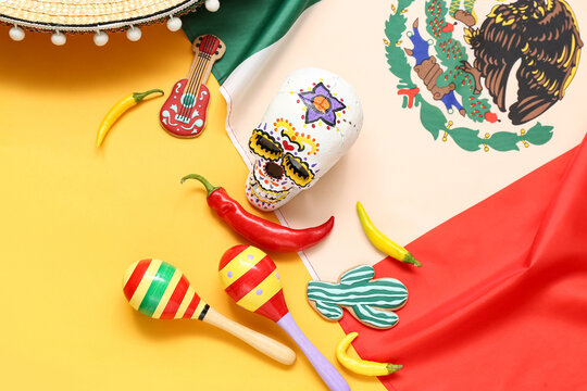 Painted sugar skull, maracas, Mexican flag and chilli peppers on yellow background. Mexico's Independence Day celebration - Powered by Adobe