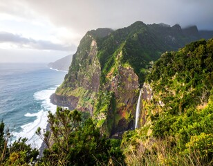 Ocean meets verdant mountain range with waterfall under cloudy sky