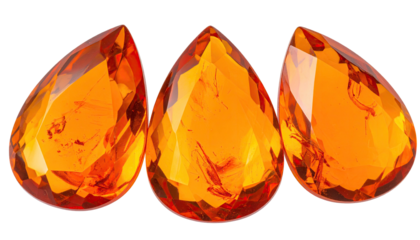 Three orange teardrop gems, faceted and shiny on black background