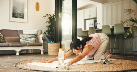 Woman, yoga and stretching with tablet in home for tutorial, online class or fitness exercise. Active, female person or yogi with technology for flexibility, child pose or virtual lesson in house