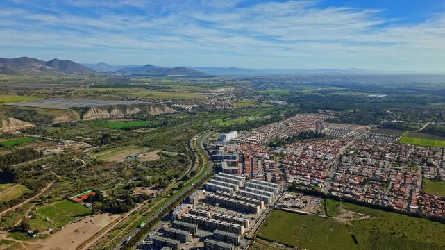 Aerial view establishing shot of the city of Ovalle in the Limar&iacute; Valley, surrounded by nature, grape plantations, and condominiums, northern Chile.