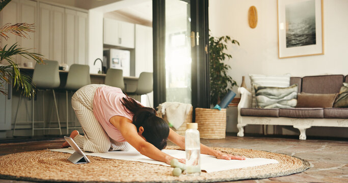 Woman, stretching and yoga with tablet at house for fitness, online class and balance with core strength. Female person, childs pose and tutorial video for flexibility, inner peace and zen wellness