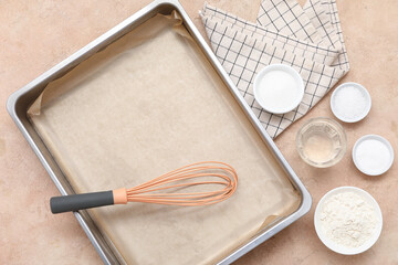 Composition with baking tray, whisk and ingredients for preparing pastry on color background