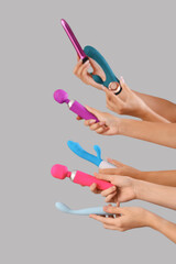 Women with vibrators on grey background