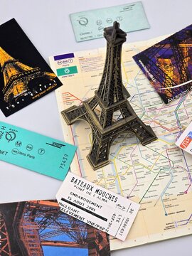 A Parisian travel collection featuring an Eiffel Tower model, a map of the metro, tickets, and postcards, suggesting a recent trip to France. February 13, 2025, Paris, France