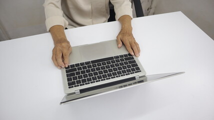 businessman hands searching for data on Notebook with analyzing charts at his workplace.