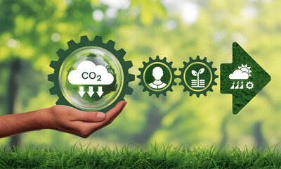 Sustainable future concept hand holds CO2 reduction gears moving towards growth and clean energy