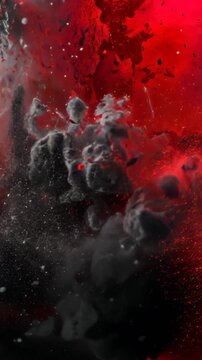 Vertical video: Red and black droplets falling, causing gray cloud and red fluid mixing in lab tank