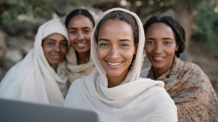 Smiling group of refugee women learning online tools for business and communication, symbolizing confidence, self-sufficiency, and transformation through digital empowerment. cinematic color
