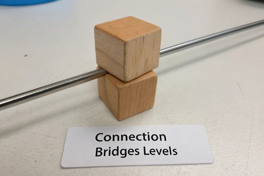 Stacked wooden cubes joined by a diagonal metal rod demonstrating connection and levels