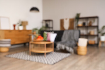 Blurred view of living room with sofa, candles and fruits for Kwanzaa celebration on table
