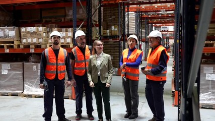 Female warehouse manager training new employees - Powered by Adobe