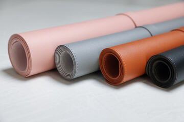 Fototapeta premium Different rolled computer mats on light grey table, closeup