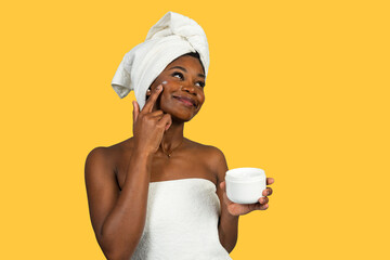 African american woman applying face cream