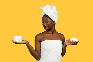 Black woman holding cream jar and lid for skincare