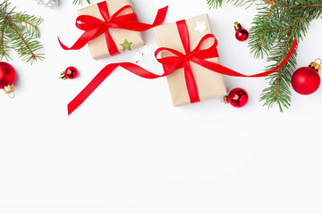Fir tree branches, gift boxes and Christmas decor on white background, flat lay. Space for text