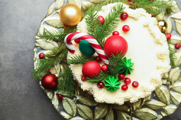 Tasty cake with Christmas decor on grey table, top view