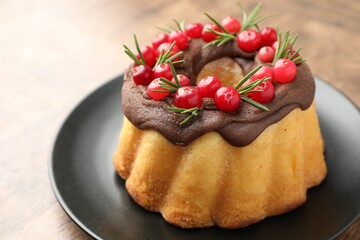 Tasty Christmas cake with cranberries on wooden table, closeup. Space for text