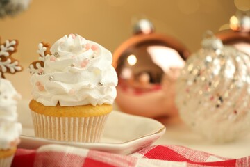 Festive cupcake with cookie on table, closeup. Christmas treat