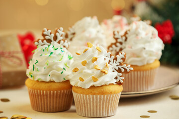 Festive cupcakes with cookies on white table, closeup. Christmas treat