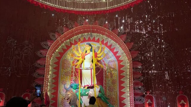 Priest offering prayer during Durga Puja festival in Kolkata, India