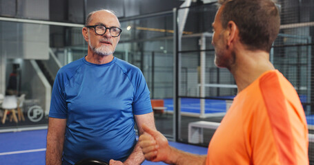 Padel, coach and men on court, talking and planning for match, fitness and strategy for...