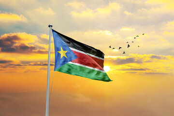 South Sudan flag waving in sunset or sunrise. South Sudan flag for Republic Day and Independence Day.