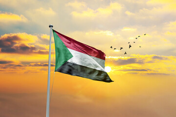 Sudan flag waving in sunset or sunrise. Sudan flag for Republic Day and Independence Day.