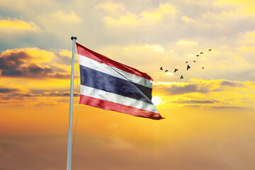 Thailand flag waving in sunset or sunrise. Thailand flag for Republic Day and Independence Day.