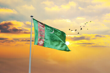 Turkmenistan flag waving in sunset or sunrise. Turkmenistan flag for Republic Day and Independence Day.