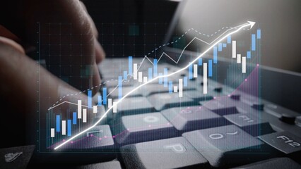 Close-up of a computer keyboard with financial graphs and trends overlaid, symbolizing analysis and insights into business performance and market dynamics. Copula