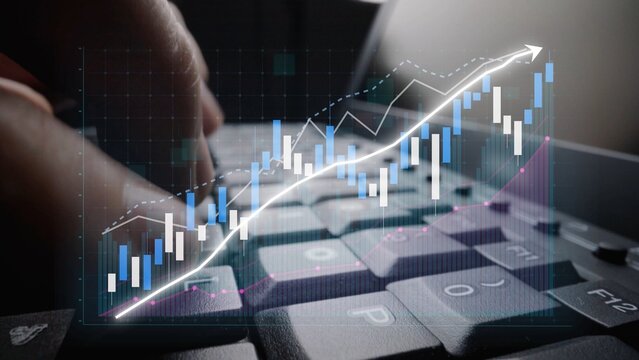 Close-up of a computer keyboard with financial graphs and trends overlaid, symbolizing analysis and insights into business performance and market dynamics. Copula - Powered by Adobe