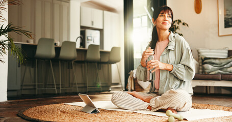 Thinking, water bottle and yoga with woman on floor in living room of home for online holistic course. Drink, tablet and vision with mature yogi person in apartment for virtual health tutorial © PeakCC/peopleimages.com