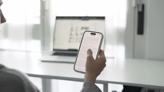 Woman reading article on smartphone indoors
