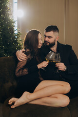 Couple celebrating christmas with glasses of wine