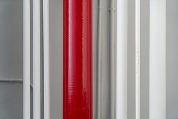 Red Column Surrounded by White Pipes